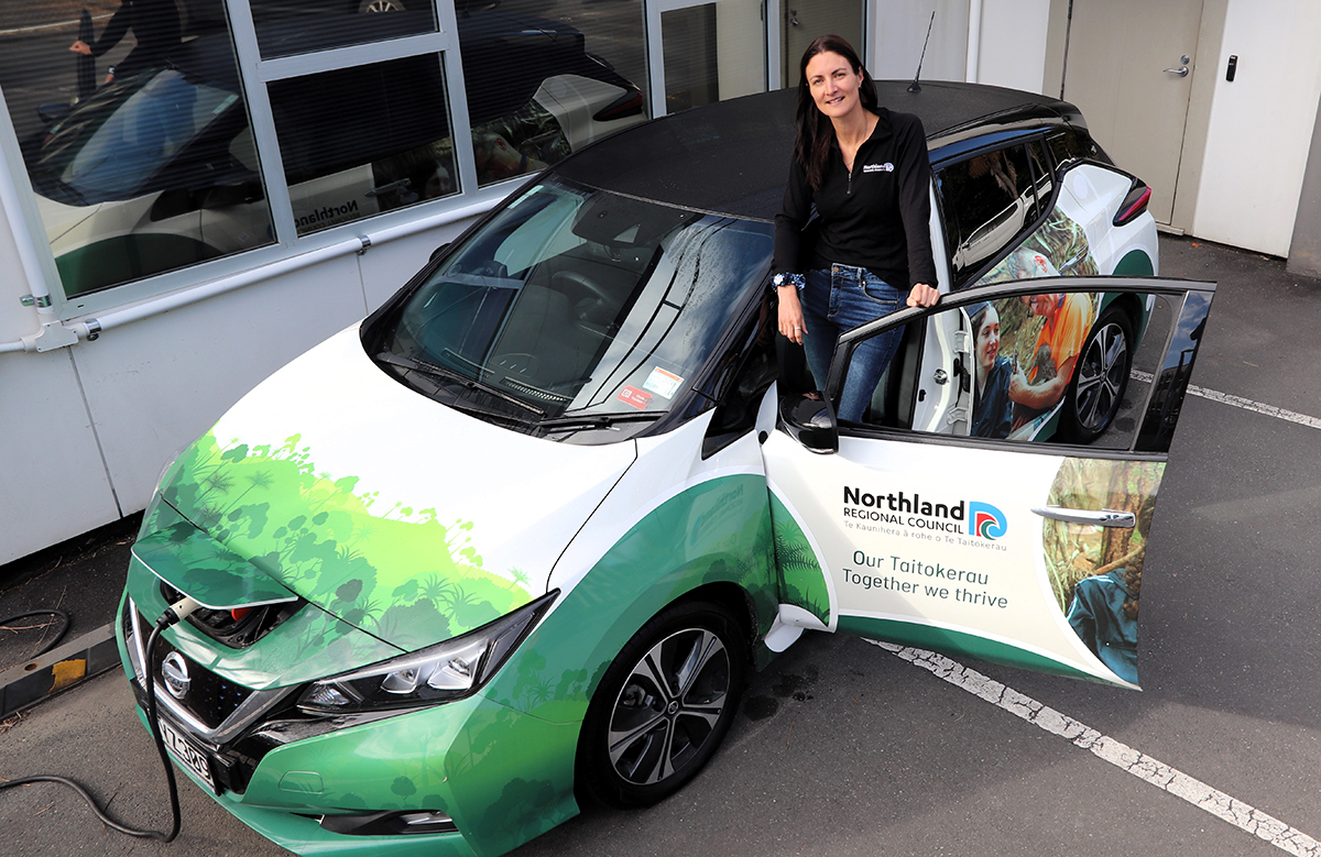 Woman in NRC electric vehicle.